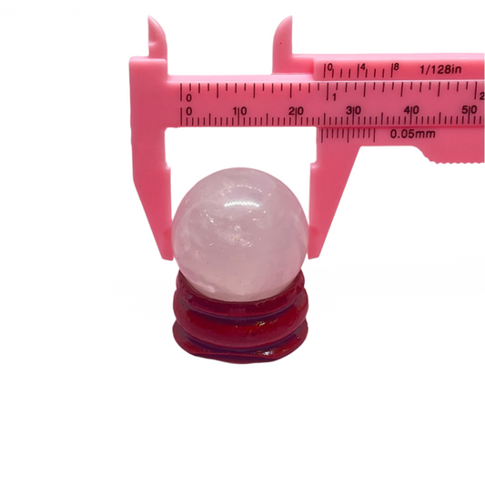 1-inch rose quartz sphere on a wooden stand, promotes love, compassion, and harmony, perfect for desks, shelves, or altars.