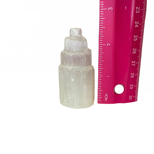 Selenite tower, clears negative energies, amplifies other crystals, supports meditation and spiritual awareness; symbolizes energy amplification, focus, and stability.
