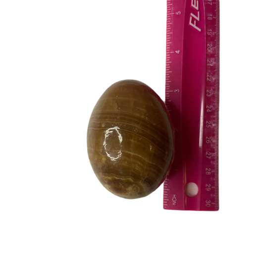 Banded Calcite egg with layered earthy tones, promotes emotional balance, personal growth, and new beginnings.