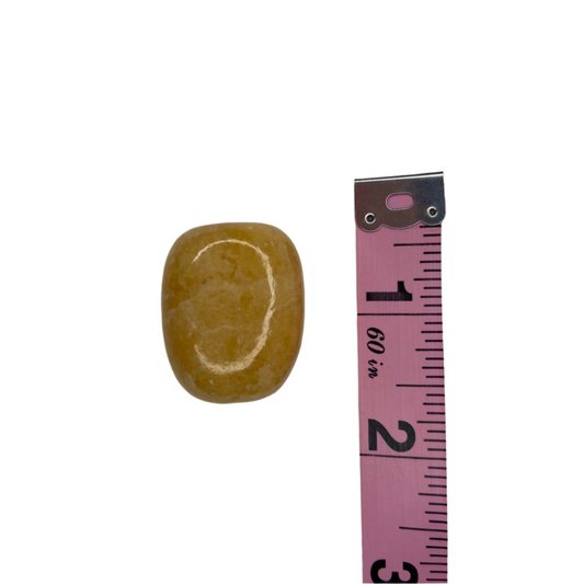 Orange calcite tumble (Stone of Amplification), energizes, enhances creativity, supports spiritual awareness, and restores positivity; symbolizes smooth energy flow, ease, and gentle guidance.
