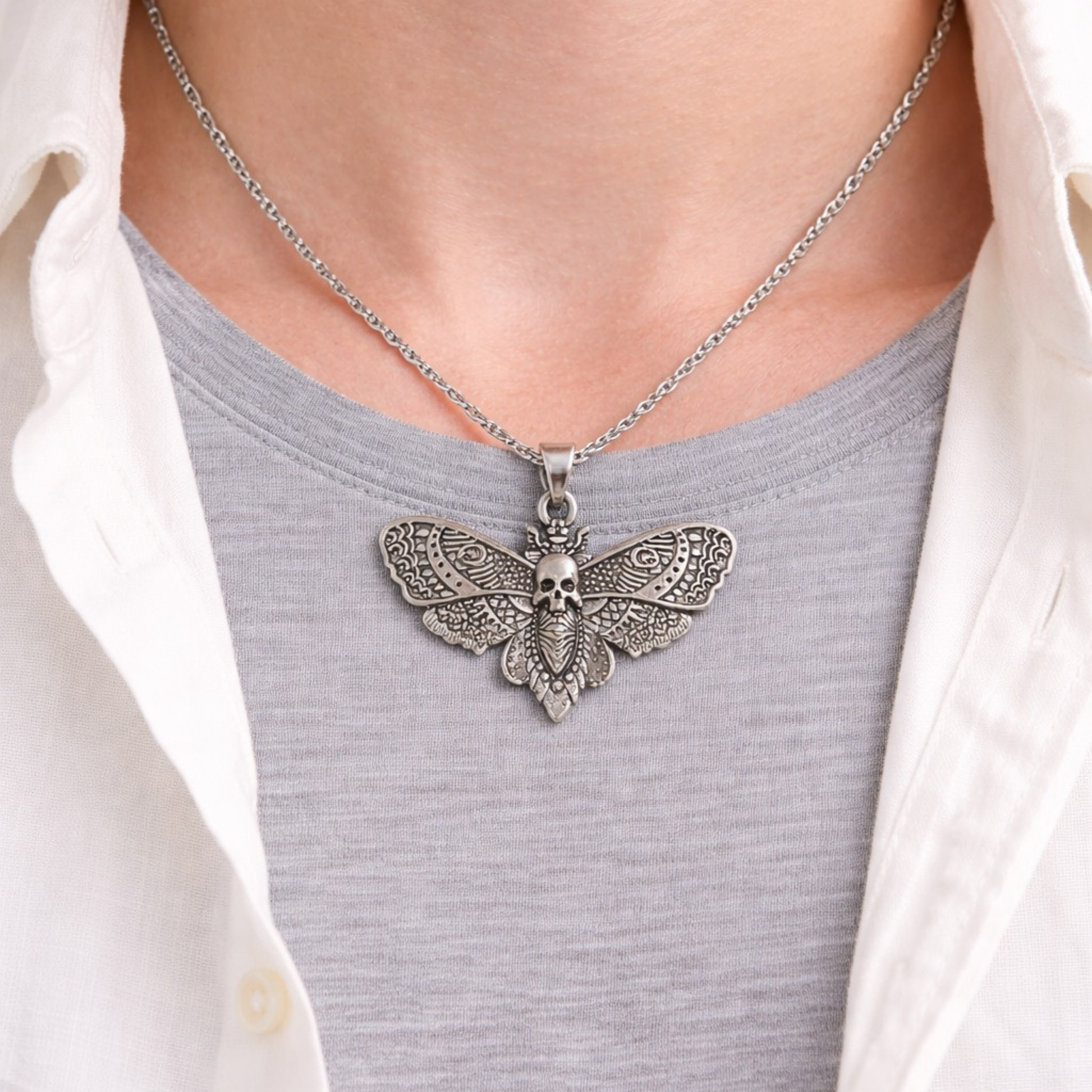Silver tone skull moth necklace with detailed wings nature-inspired statement jewelry