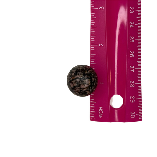 Small rhodonite sphere, promotes compassion, emotional healing, self-awareness, and connection; symbolizes wholeness, unity, and balanced energy.
